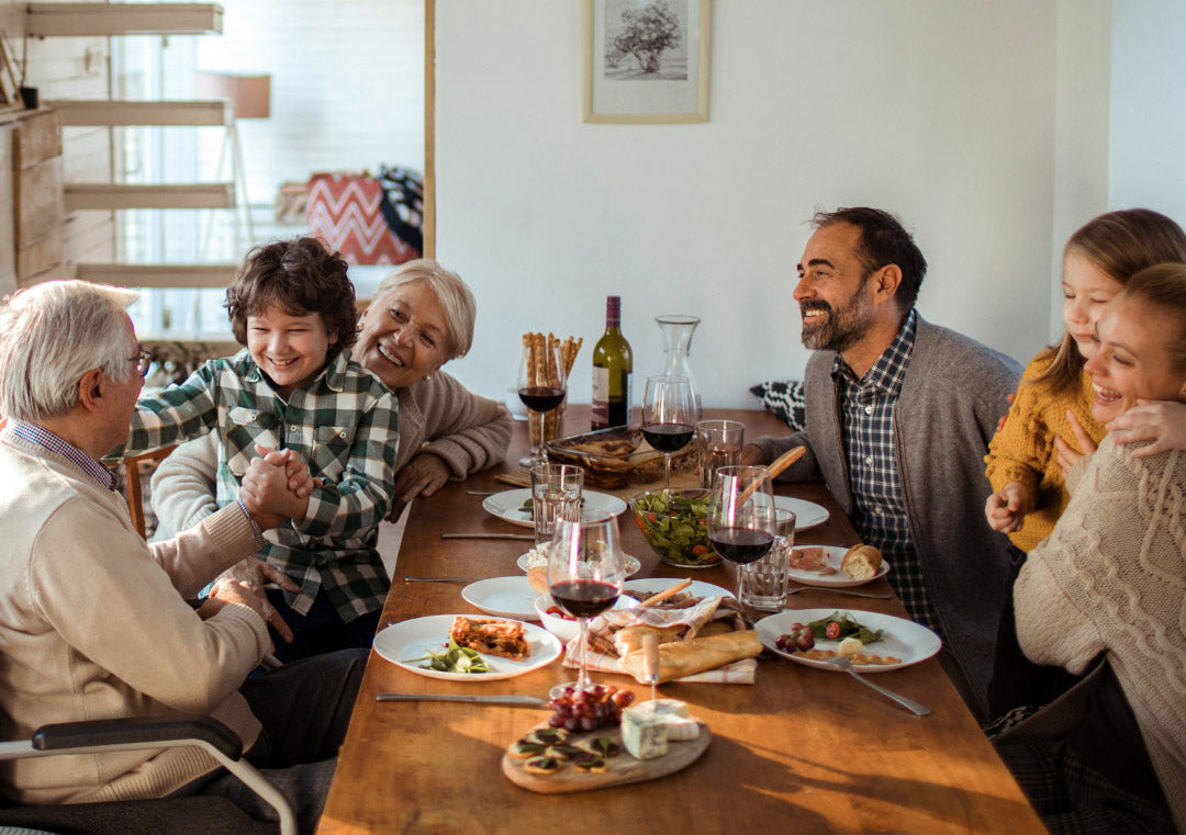 Smiling family having holiday dinner at dinner table.