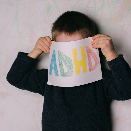 Child holding ADHD sign