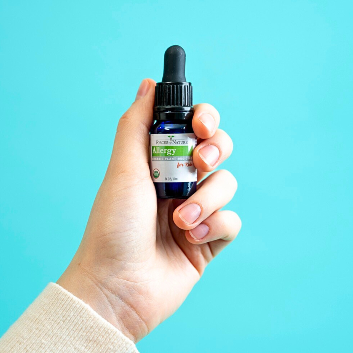 Forces of Nature Allergy for Kids 10ml bottle dropper held in hand.