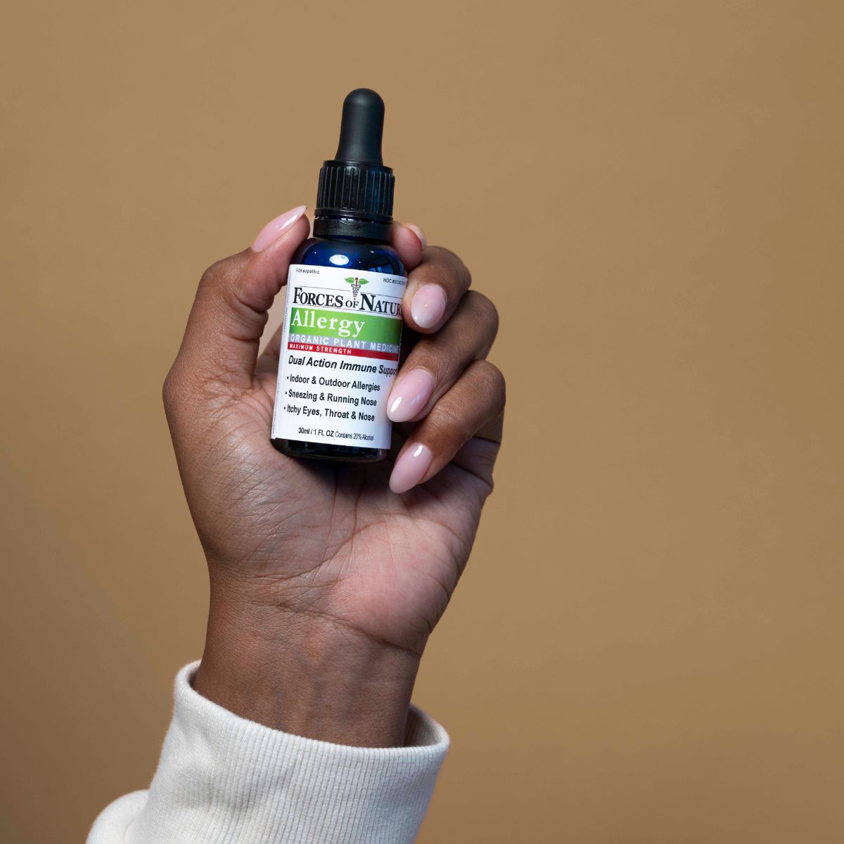 Forces of Nature Allergy Max Strength 30ml bottle held in hand.